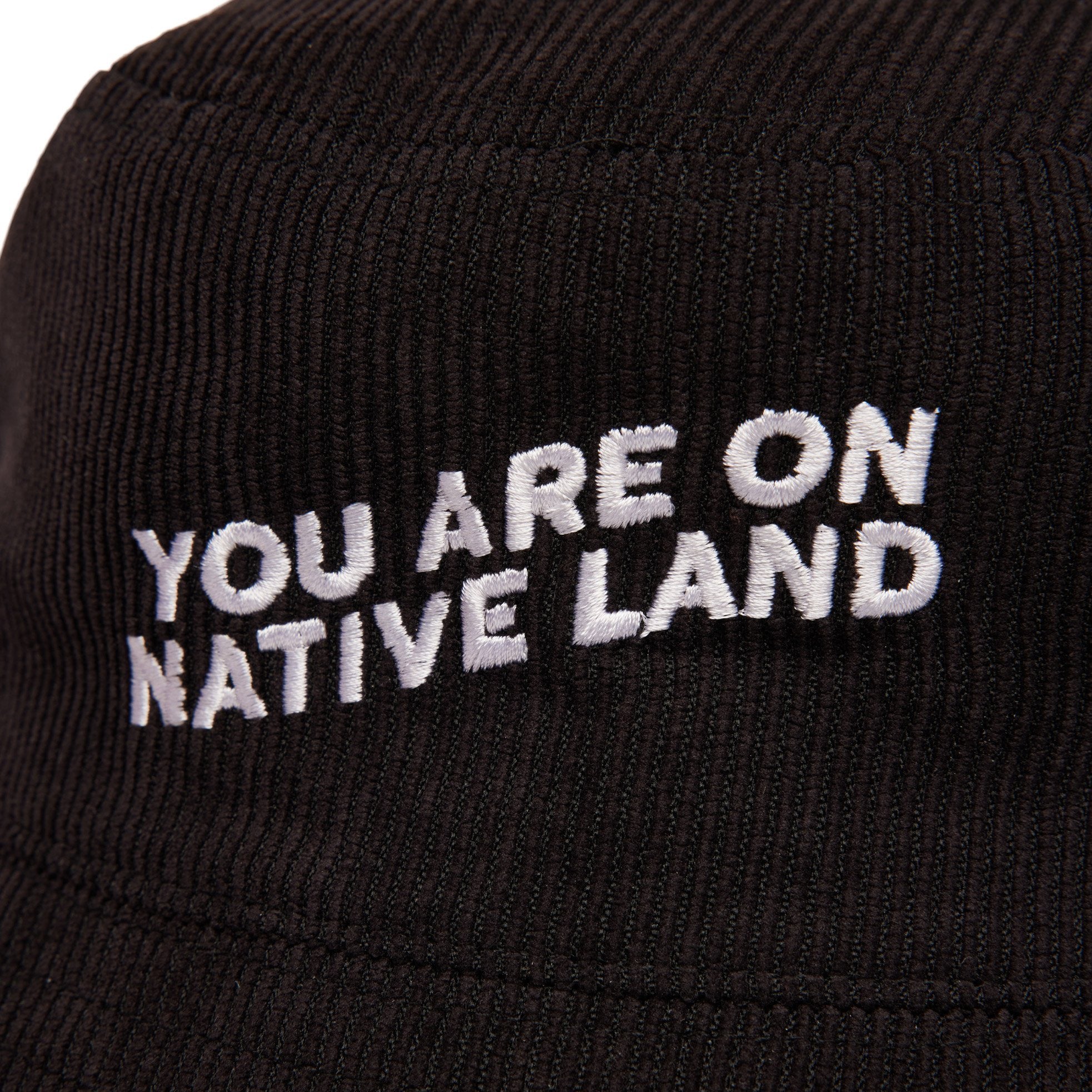 'YOU ARE ON NATIVE LAND' CORDUROY BUCKET HAT - BLACK