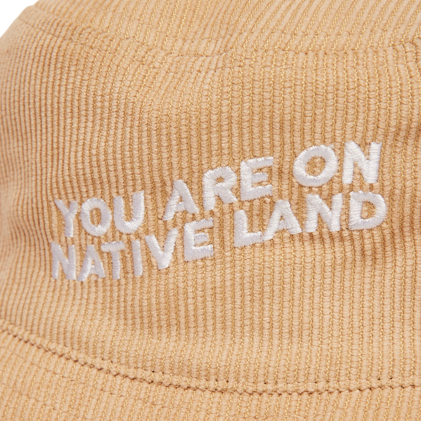 'YOU ARE ON NATIVE LAND' CORDUROY BUCKET HAT - TAN